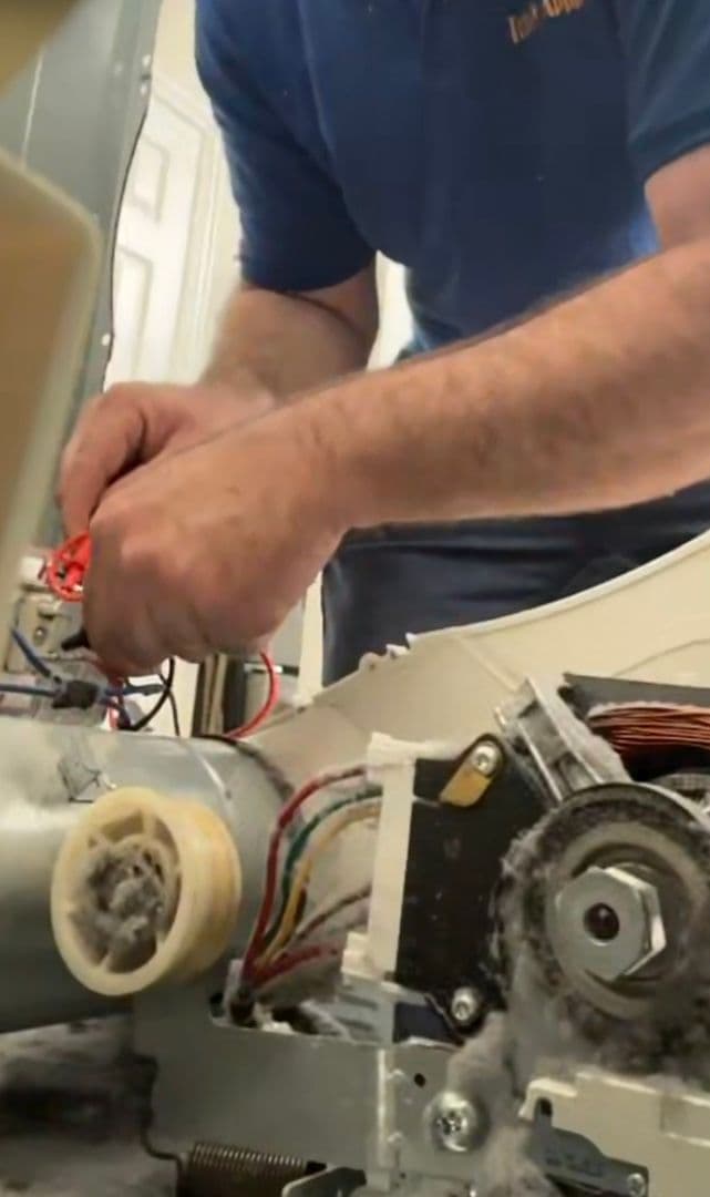 Jason's hands on a washer drive motor